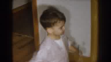 Nebraska (1957): Young Boy On Knees Scooting To A Bed While Carrying His