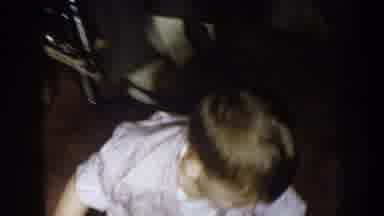 Nebraska (1957): Boy Wearing Brown Pants Climbs Onto Lap Of Man Wearing Blue Plaid