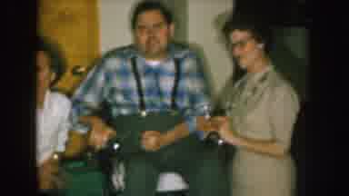 Nebraska (1957): Two Women Pose With Man Wearing Blue Shirt Sitting In Wheelchair