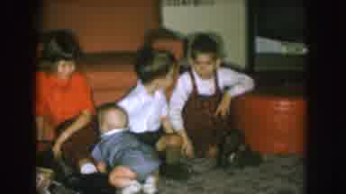 Nebraska (1957): Three Young Children And A Crawling Baby Sitting On The Floor In