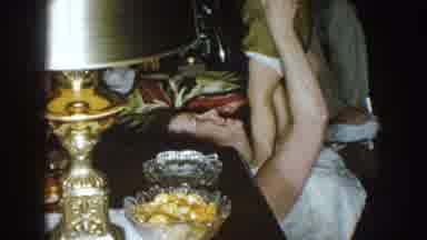Nebraska (1957): A Woman Plays With Her Baby In A Gathering Of People