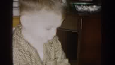 Nebraska (1957): Boy Wearing Brown Shirt Eats Snack From Black And White Bowl
