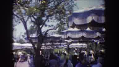 Disneyland California (1962): People Strolling And Others Under An Umbrella To