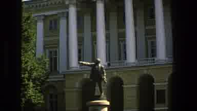 Denmark (1975): Red Flag Waving In Front Of Sky Cuts To Bronze Statue In Front Of