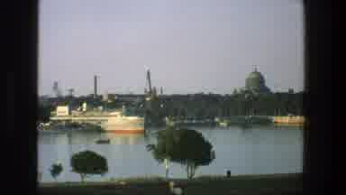 Denmark (1975): A Ship Is Docked In A Channel With A Seawall And A Shoreline With