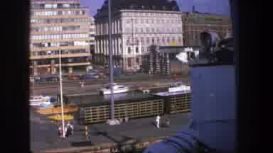 Denmark (1975): A View Of A City With Buildings And Cars From A Cruise Moving Next
