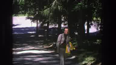 Denmark (1975): A Woman In Gray Suit Smiles At Her Audience And Walks Past Him