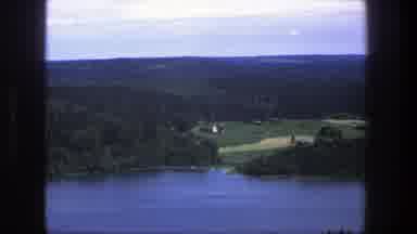 Denmark (1975): A Landscape Of A Lake With A Forest Of Cone Trees At The