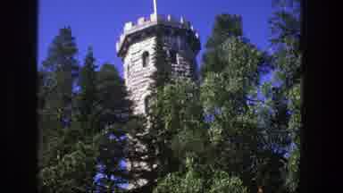 Denmark (1975): There Is Castle Like Tower Located Behind Some Large Trees