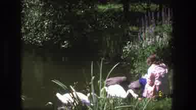 Denmark (1975): Archival Footage Of A Young Woman Sitting On The Shore And Feeding