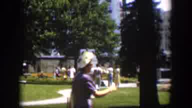 Wyoming (1951): A Woman Walks Past A Group Of People Mingling Together