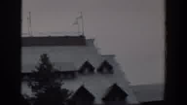 Wyoming (1951): View Of Building With White Roof And Green Tree On A Clear Day