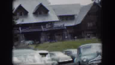 Wyoming (1951): View Of Cars Parked Near Stone And Brown Wood Building On A Clear
