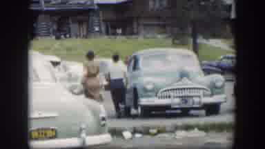 Wyoming (1951): A Mother And Her Son Walk Past Parked Cars To Find Theirs