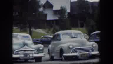 Wyoming (1951): Old Cars In A Parking Lot With Background Of Houses Behind