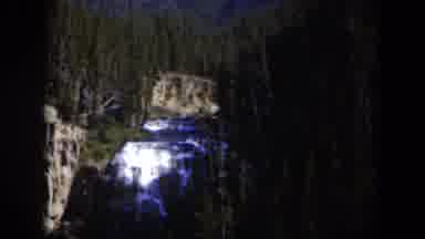 Wyoming (1951): Person Running In The Woods With Blue Waterfall Behind Him