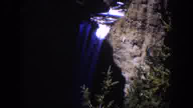 Wyoming (1951): A Stream Flows Down A Gray Cliff And Spills Over Into A Blue And