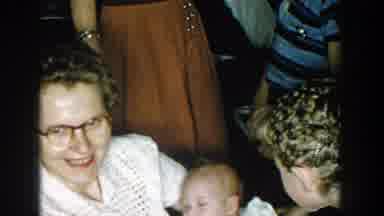 Michigan (1957): A Mother And A Group Of Boys Play With A Newborn Baby In Her