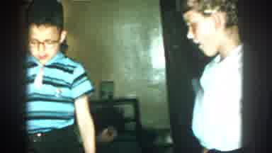 Michigan (1957): Several Boys And Girls Stand Around A Woman In Glasses Seated And