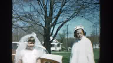 Michigan (1957): A Woman Holding A Cup Talking To Her Son With Other Women