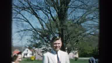 Michigan (1957): Man Wearing Light Gray Jacket Smiles For Camera On A Sunny Day
