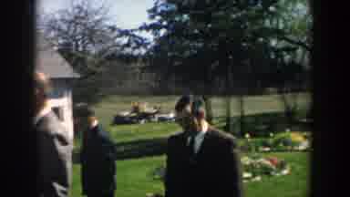Michigan (1957): People With Hats Walking Near A White Cottage In The Countryside