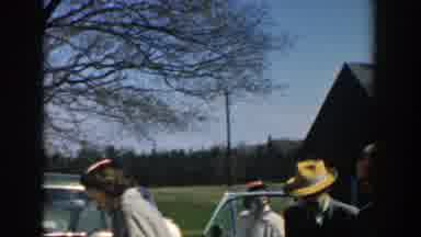 Michigan (1957): Many People Standing In Front Of Cars And Barn And Field Outside