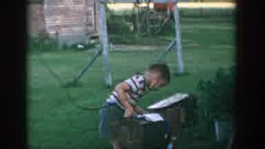 Michigan (1957): A Boy Turns Water From A Watering Can And Replaces It