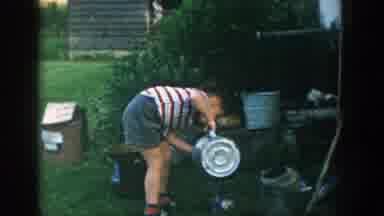 Michigan (1957): Cute Little Boy Watering A Plant