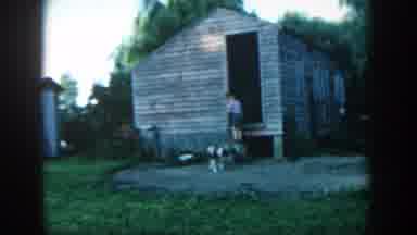 Michigan (1957): Child Waves Hand Inside Wooden Building Dog Goes To Its Place