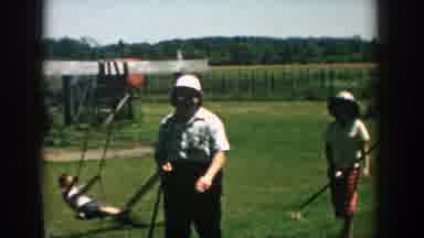 Michigan (1957): Woman And Boy Walking With Sticks In Hand In Front Of Child On A