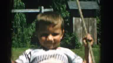 Michigan (1957): A Boy Is Having Fun As He Swings Himself Back And Forth