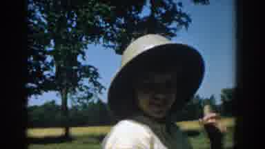 Michigan (1957): Boy Wearing A Safari Hat In A Park With A Man In The Background