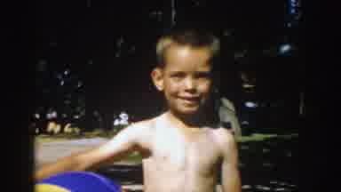 Michigan (1957): Young Boy Standing Outside Holding A Beach Ball On A Bright Sunny