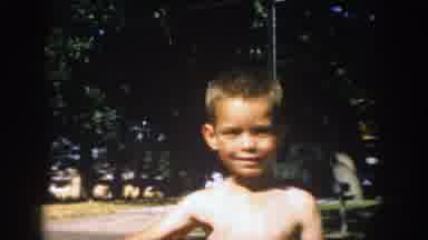 Michigan (1957): A Bear Chested Boy Smile At The Camera Man Filming Him