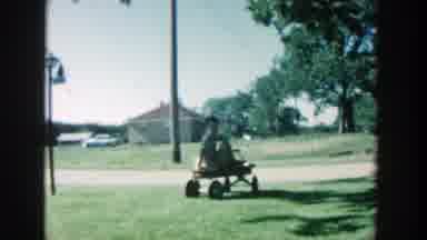Michigan (1957): A Little Kid Over A Red Wagon On A Big Field Of Grass At A Farm