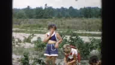 Michigan (1957): A Group Of Men And Women With Children Farming With Their Bear