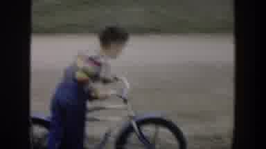 Cuba (1951): Two Boys Having Fun Riding A Bicycle Running Besides A Red Car