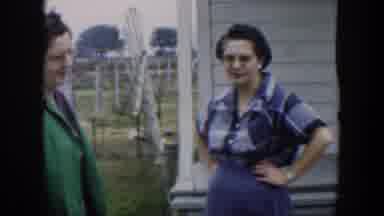 Cuba (1951): Woman Wearing Green Coat And Glasses Talks To Woman Wearing Blue
