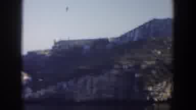 Cuba (1951): View Of Tan Building On Edge Of Green And Grey Cliff On A Sunny Day