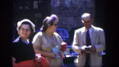 Cuba (1951): Group Of People Stand In Parking Area Chatting Vintage Vehicles In