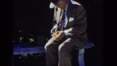 Cuba (1951): A Man In Suit Woulds An Object In His Hands As He Sits