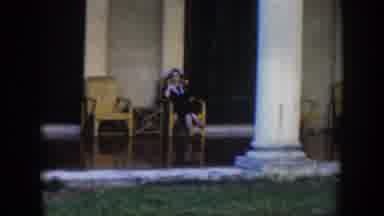 Cuba (1951): Woman Sitting On A Wooden Chair On Her Porch Transitioning Into A