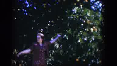 Cuba (1951): A Woman In A Dress And Hat Walks Between Two Large Citrus Trees And