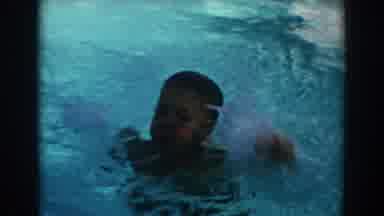 North Hollywood California (1962): A Boy Swims In A Pool Keeping His Head Above