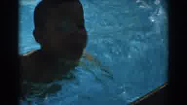 North Hollywood California (1962): A Boy Swims Out Of The Pool As His Brother Is