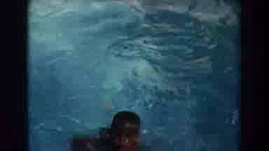 North Hollywood California (1962): A Boy Struggles To Swim In The River As He