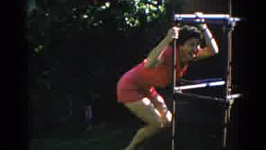 North Hollywood California (1962): A Woman Dressed In A Dark Pink Short Suit Play