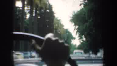 San Francisco California-1957: Person Drives Down Street Lined With Green Trees