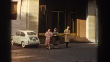 Barcelona Spain (1959): A Man In A Jacket And Two Women In Jacket Walk Together
